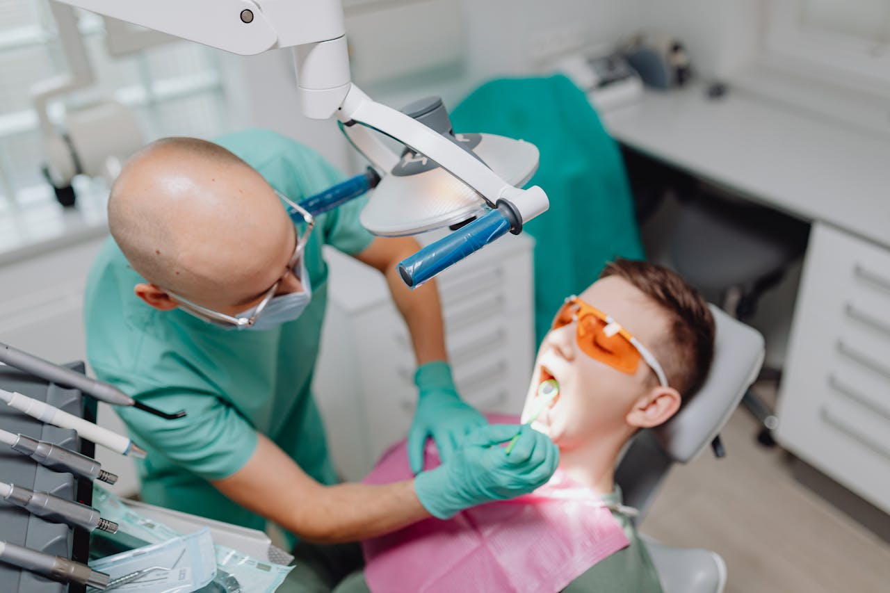 Dentist performing oral examination with patient in modern dental clinic.