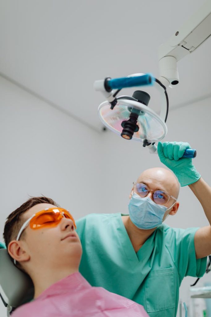 Dentist performing a dental checkup on a patient in a modern clinic setting.